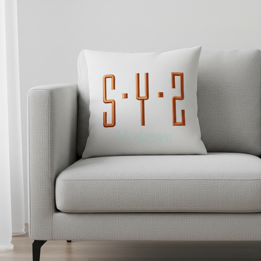 Embroidered copper geometric block monogram SYP on pillow