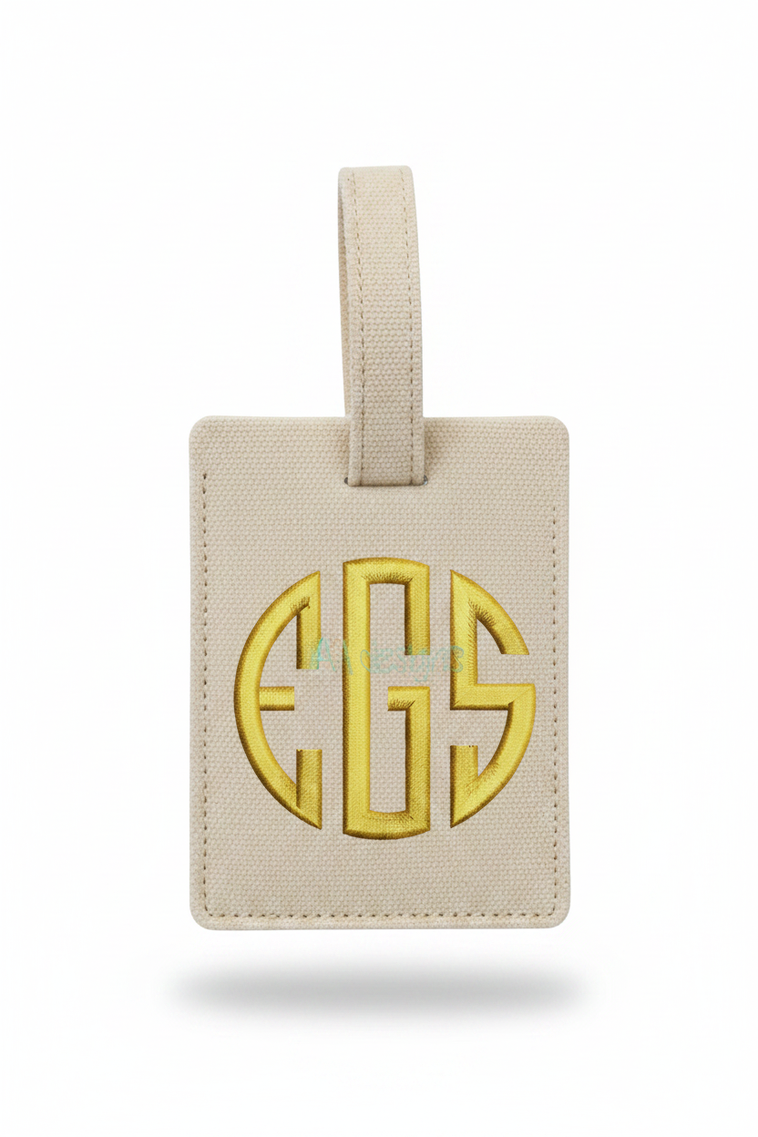 Embroidered gold circle monogram EGS on bag tag